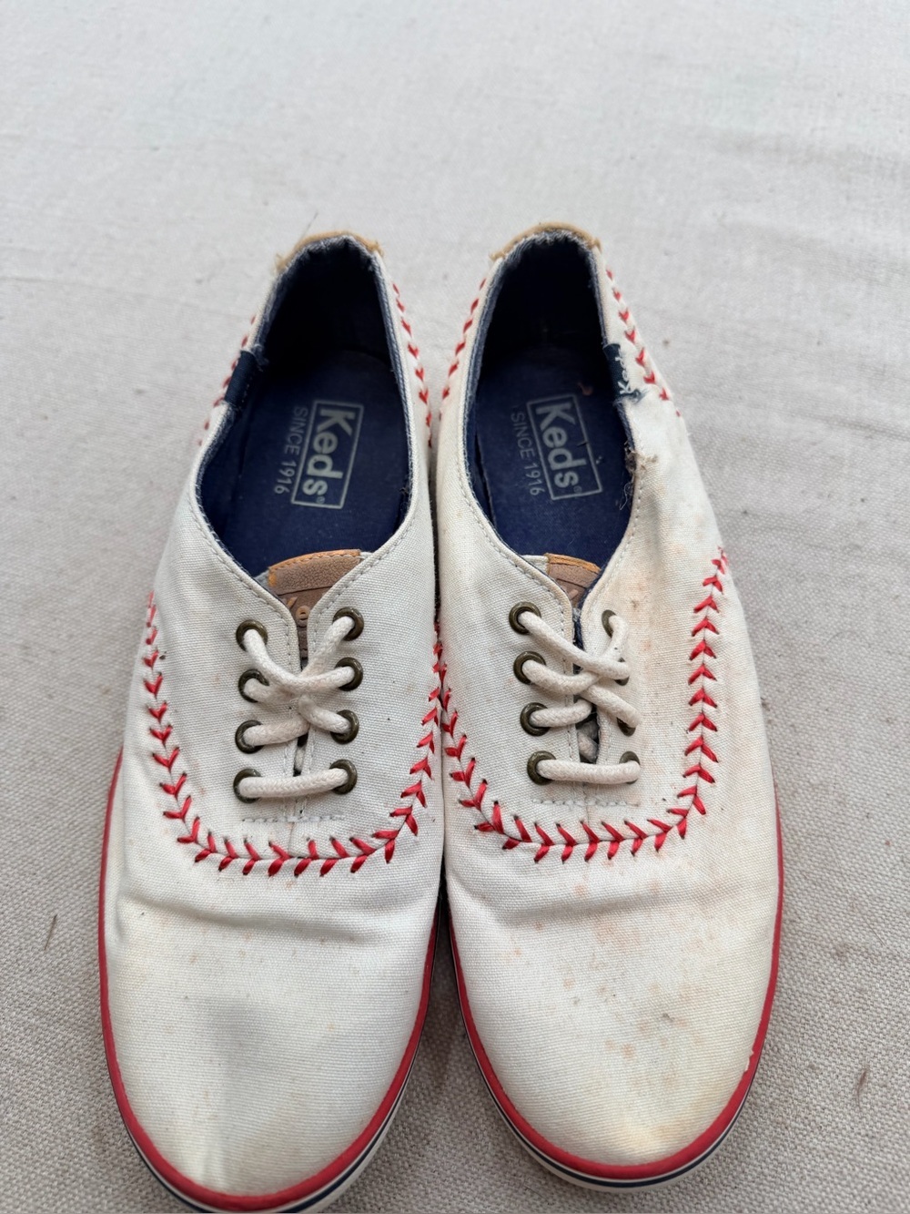 Keds white canvas baseball sneakers with navy interior and red sole trim